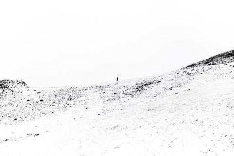 Abstract black and white photograph of a person in a mountain.